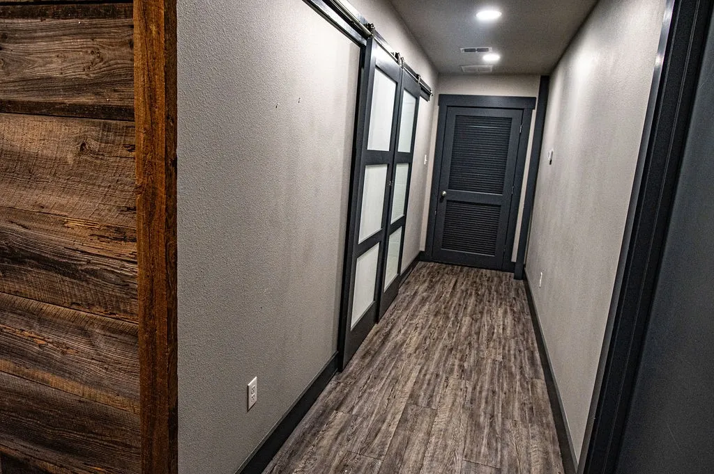 Corridor with dark hardwood / wood-style floors