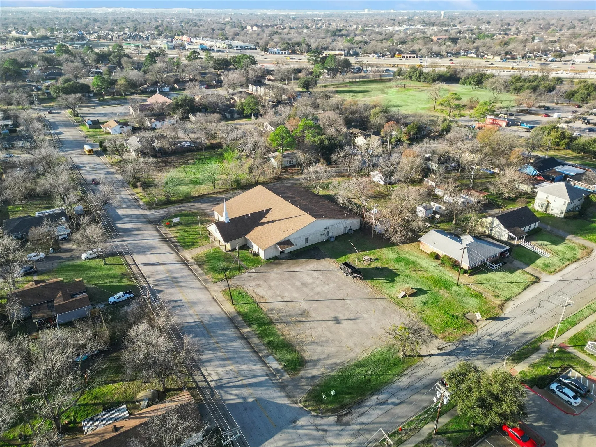 Bird's eye view of large parking lot with extra green space