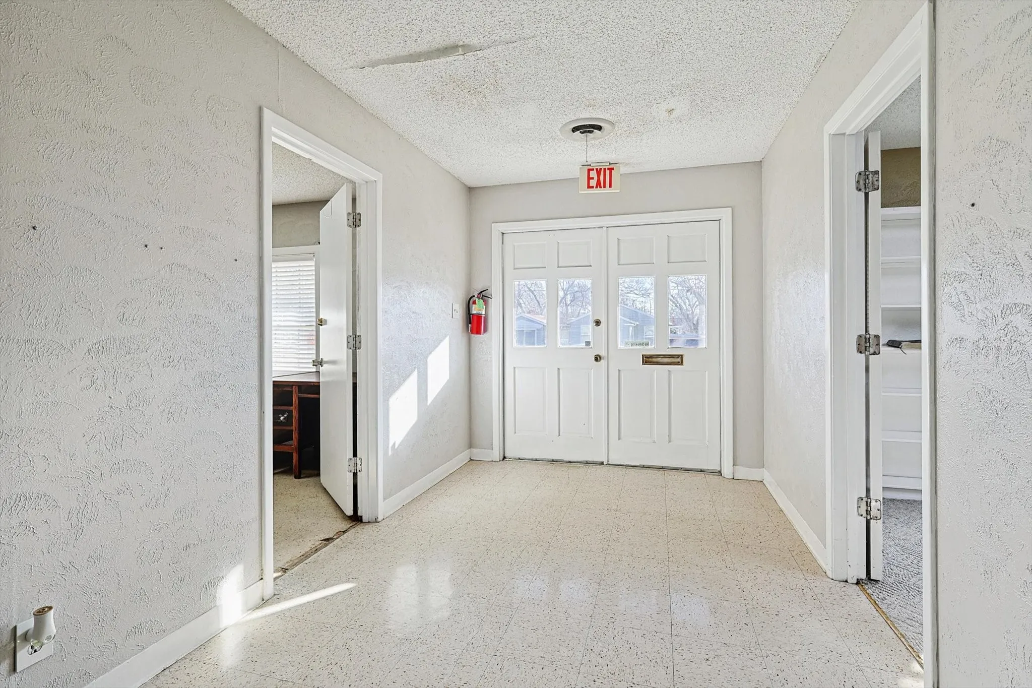 Entryway with plenty of natural light and a textured ceiling
