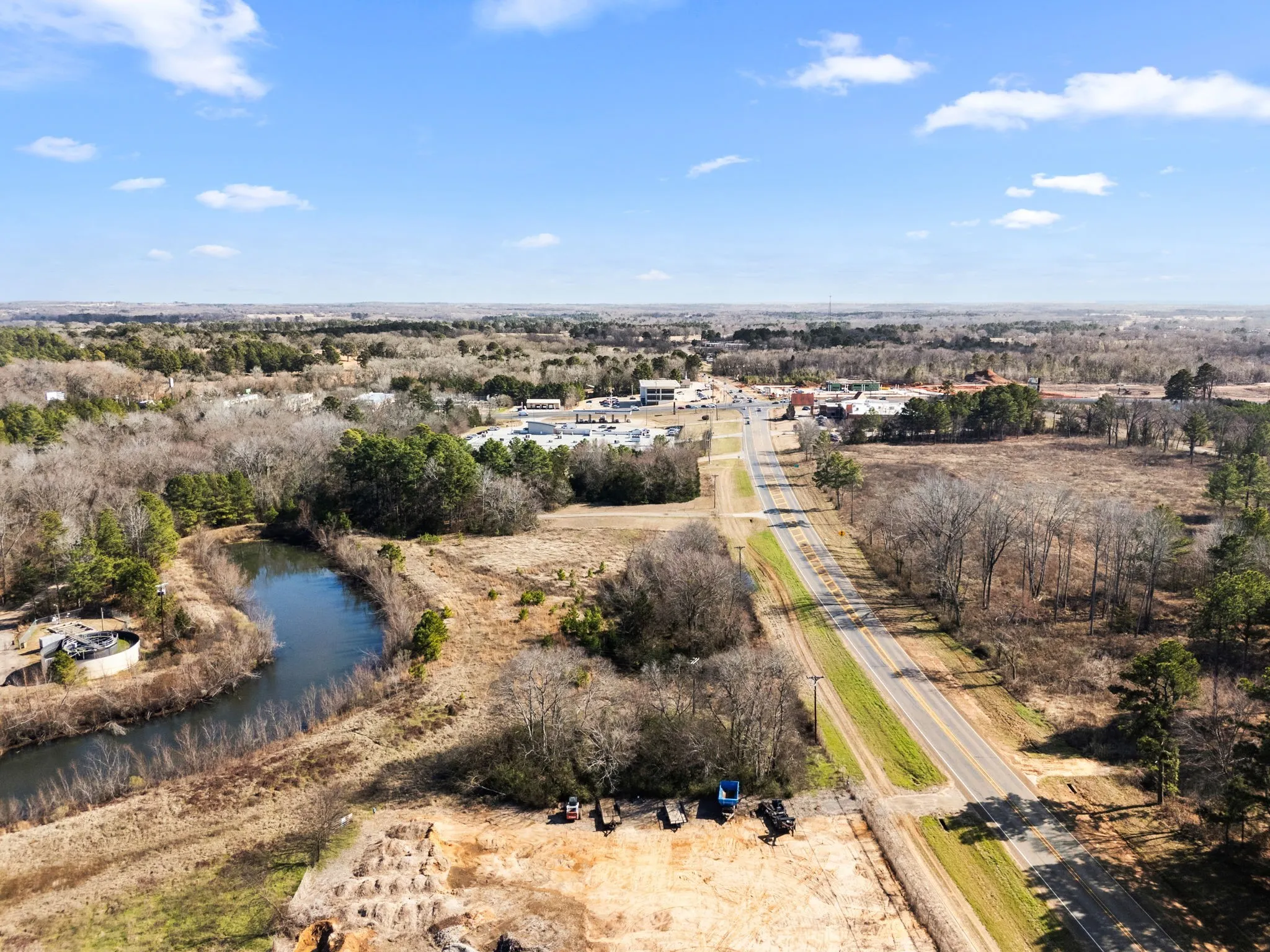 Birds eye view of property with a water view