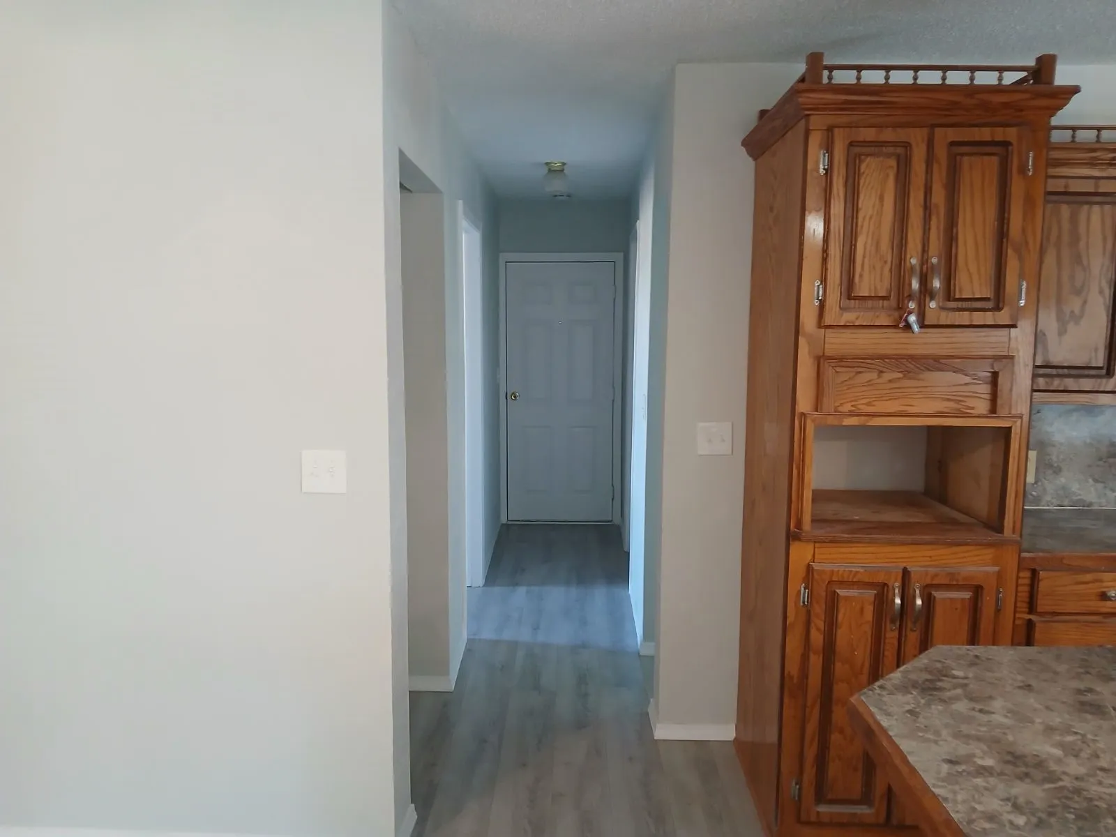 Hall with light hardwood / wood-style floors