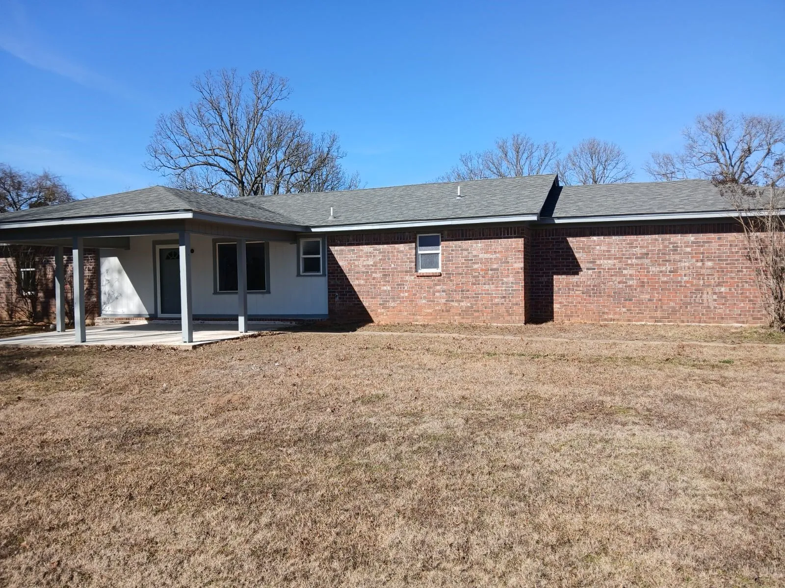 Back of property with a patio and a yard
