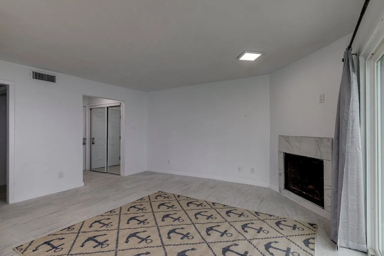 Unfurnished living room featuring a fireplace and light hardwood / wood-style floors
