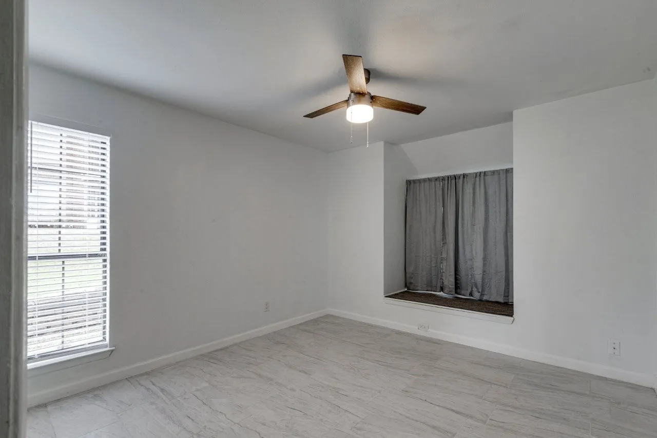 Spare room with ceiling fan