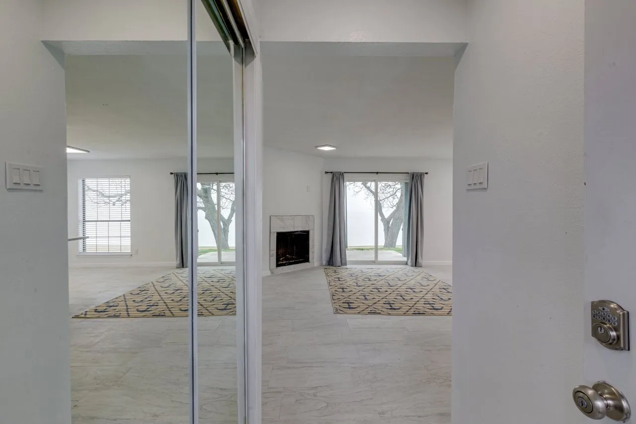Unfurnished living room featuring a premium fireplace