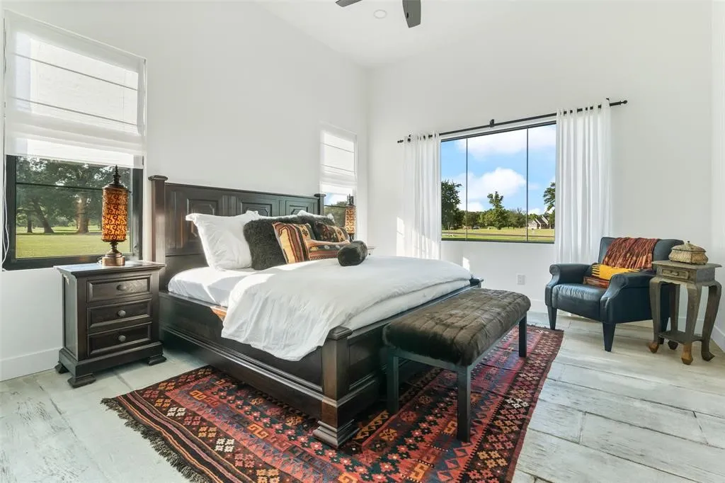 Bedroom with multiple windows, ceiling fan, high vaulted ceiling, and light wood-type flooring