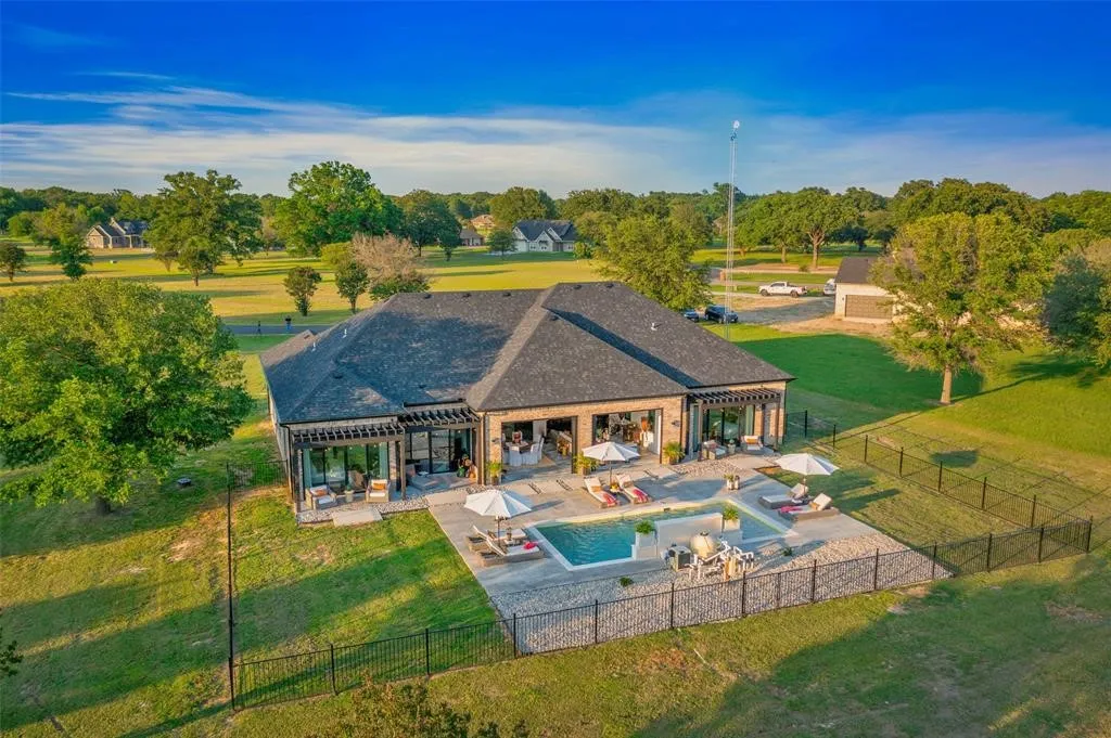 View of swimming pool with a lawn, a patio area, and a pergola