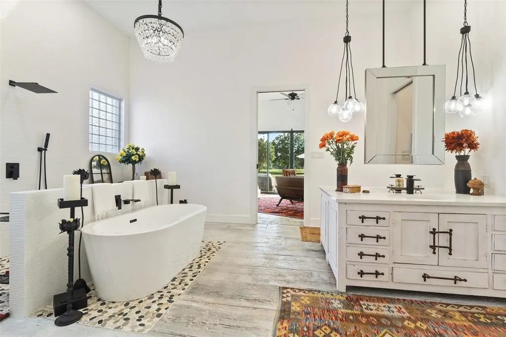 Bathroom with vanity, a tub to relax in, plenty of natural light, and wood-type flooring