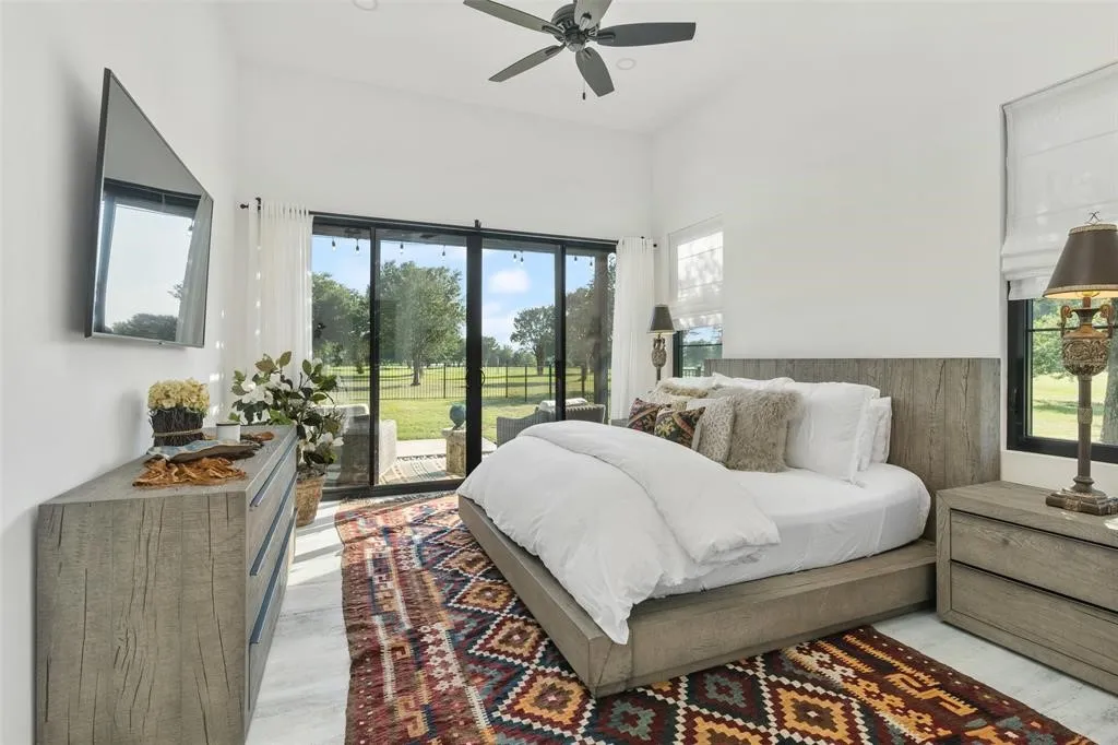 Bedroom featuring access to exterior and light hardwood / wood-style floors
