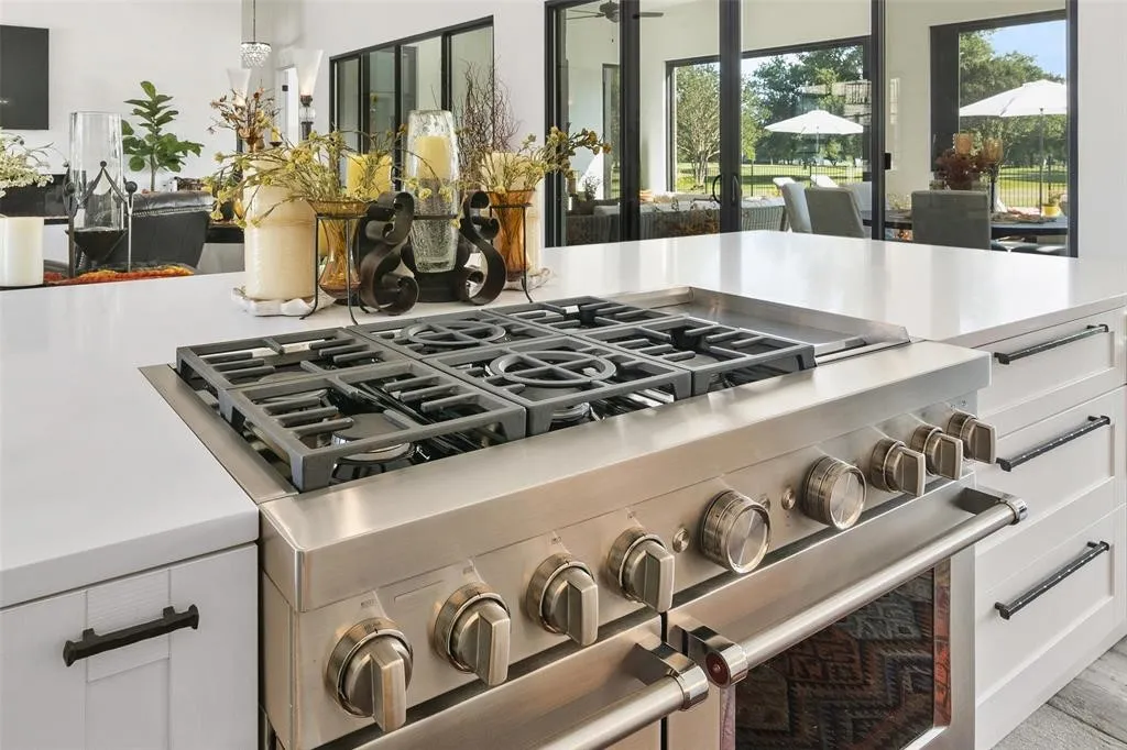 Room details with white cabinetry and double oven range