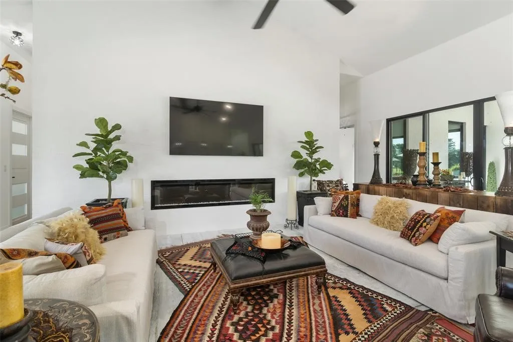 Living room featuring high vaulted ceiling and ceiling fan