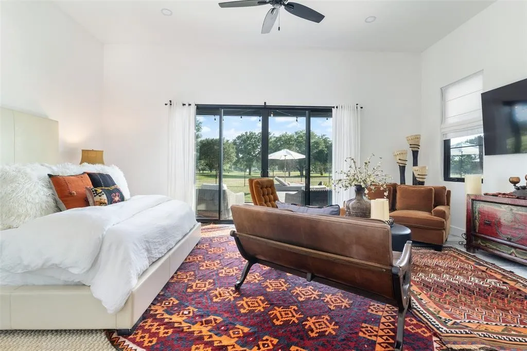 Bedroom with multiple windows, access to outside, and ceiling fan