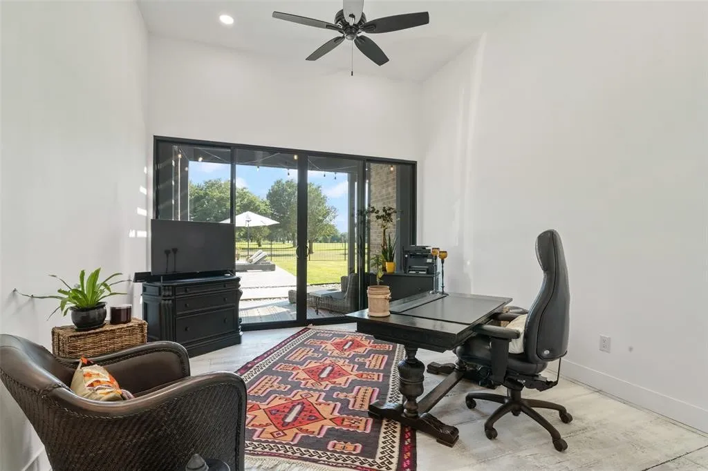 Office area featuring light hardwood / wood-style flooring and ceiling fan