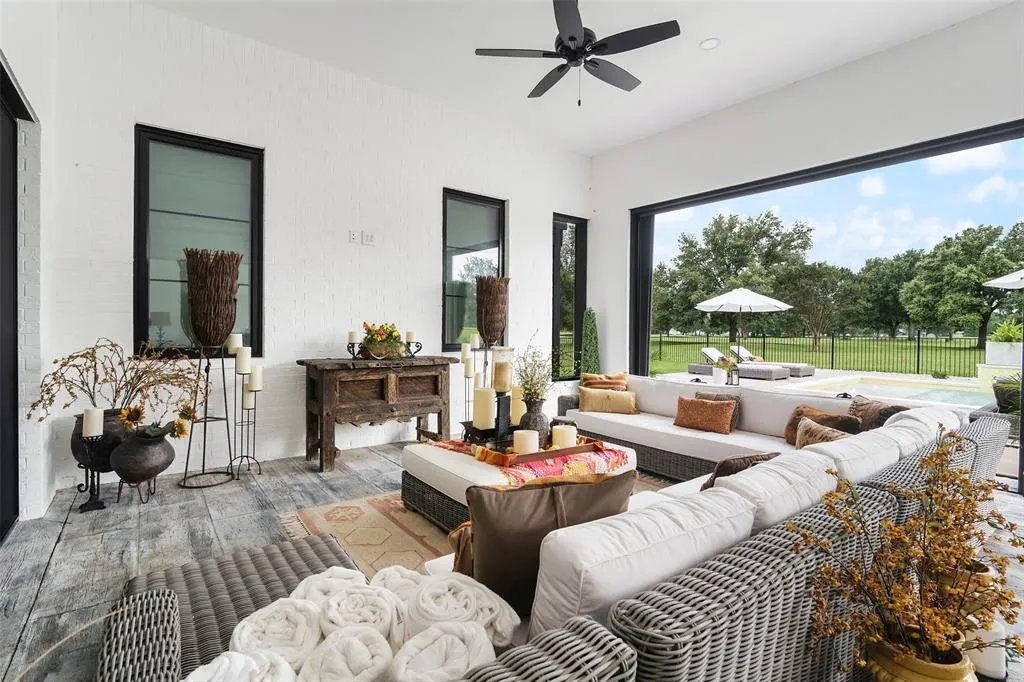 Living room with ceiling fan, plenty of natural light, and light wood-type flooring
