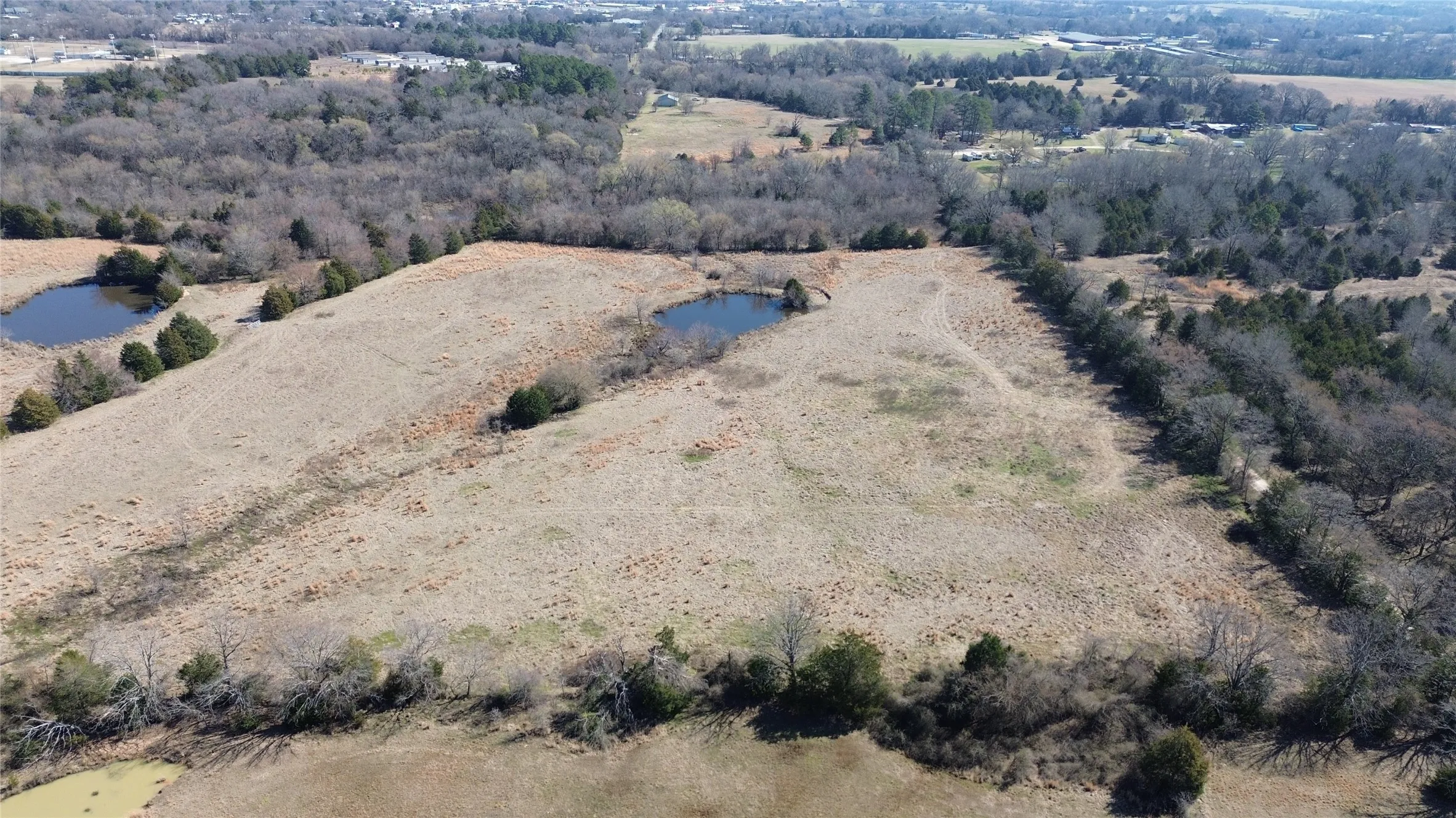 Aerial view of property and surrounding area with a large body of water