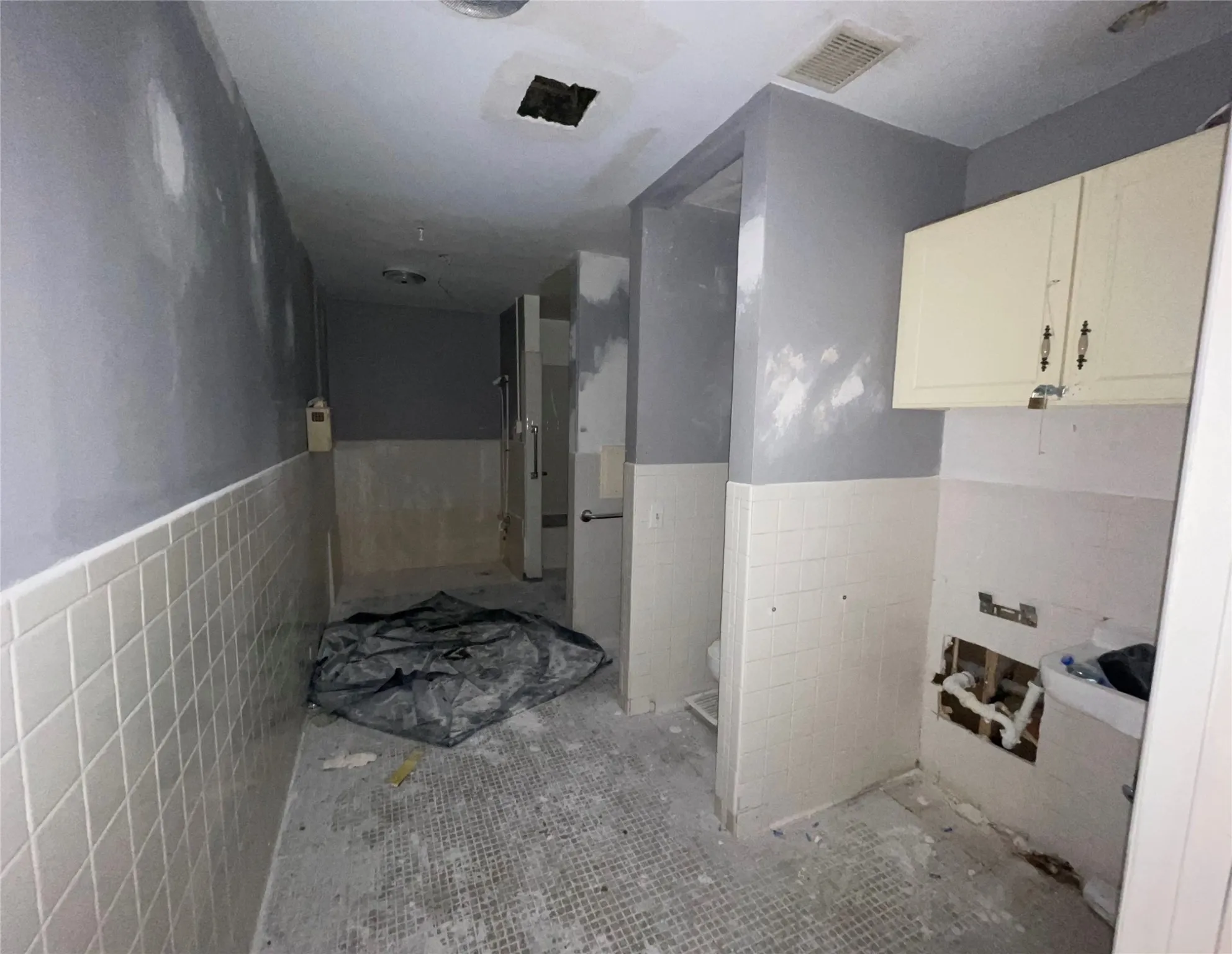 Bathroom featuring tile walls and toilet