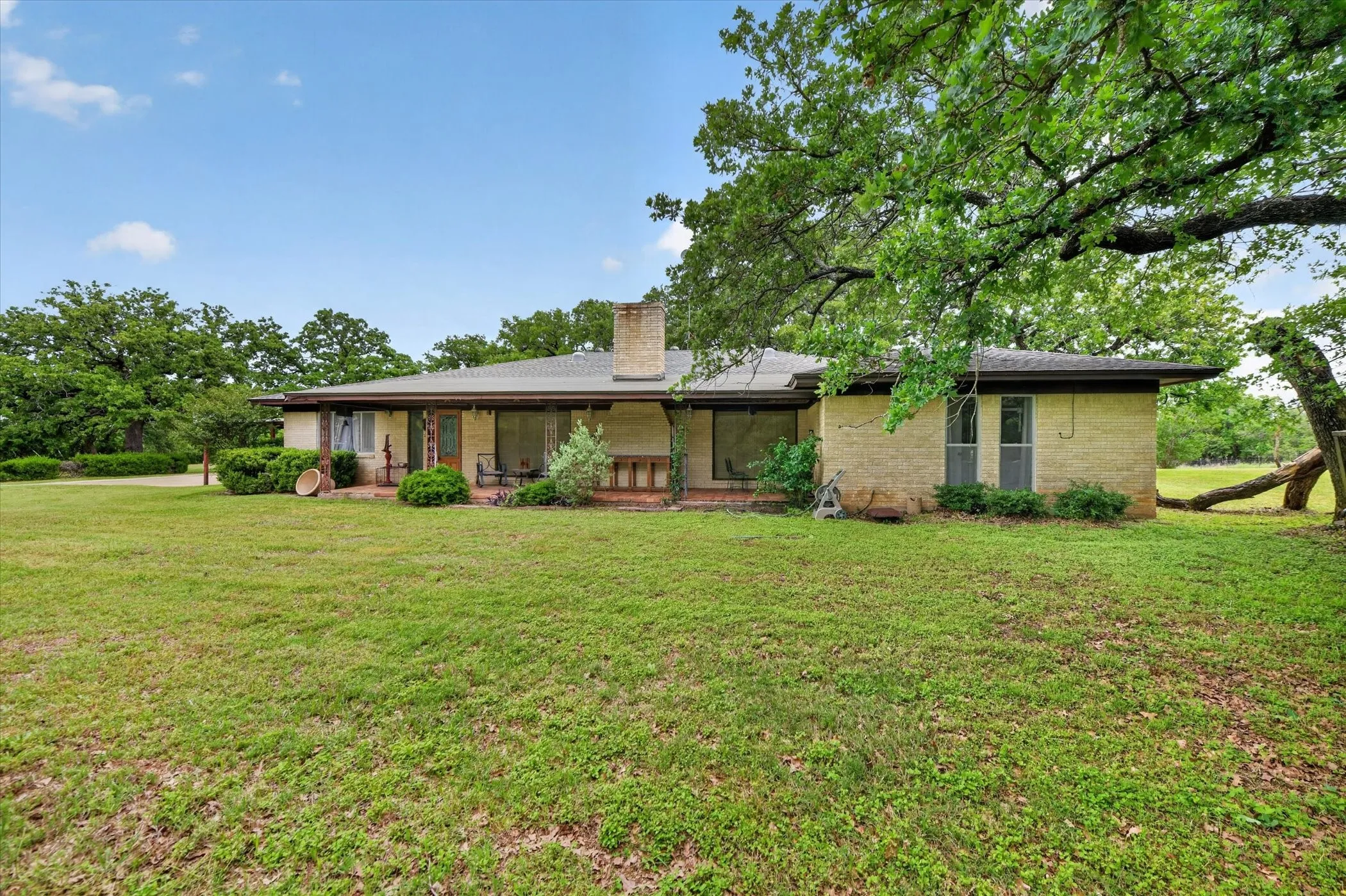 Single-story residence featuring a brick exterior and a covered front porch