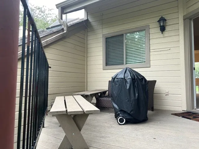 Wooden terrace featuring area for grilling