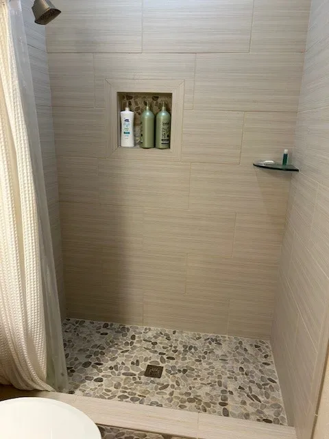 Full bath with a stall shower and toilet