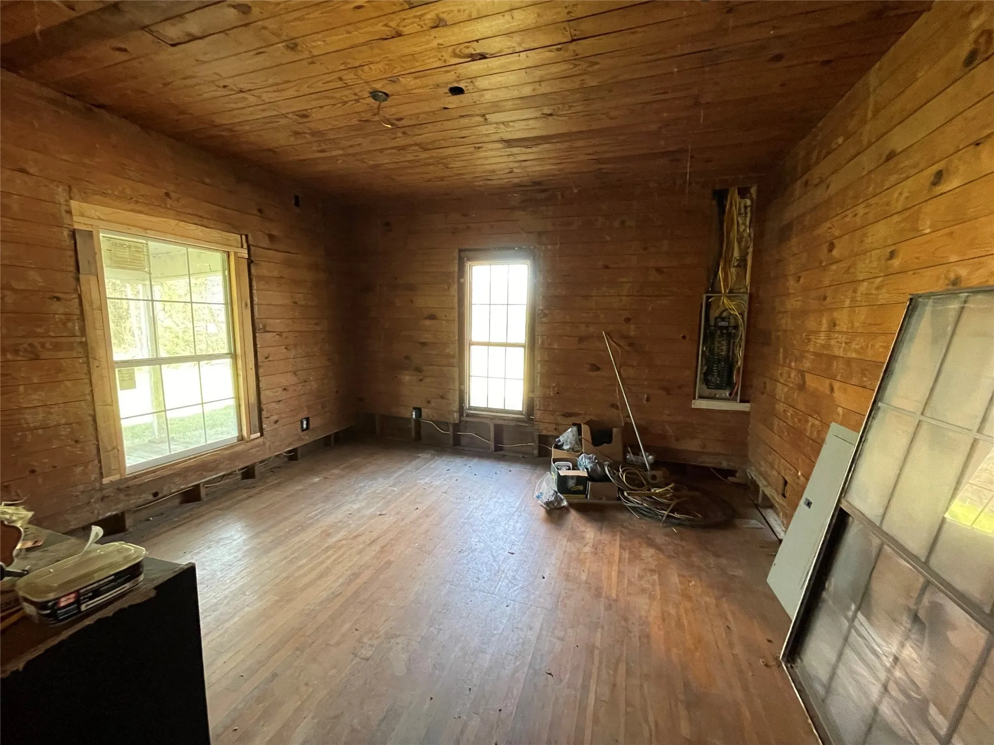 Empty room with wood walls, hardwood / wood-style flooring, and wood ceiling