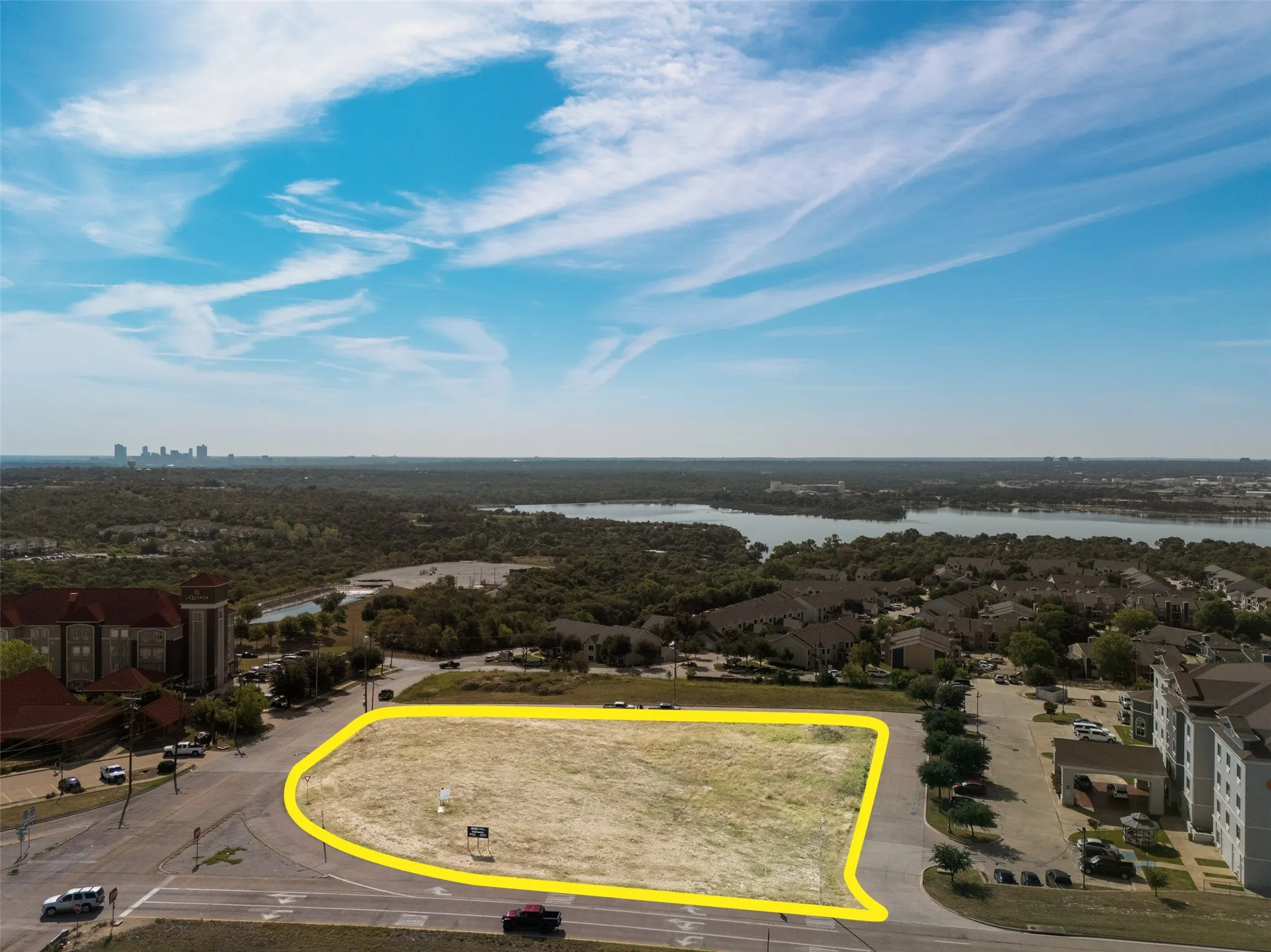 Aerial overview of property's location with a nearby body of water and property boundaries highlighted