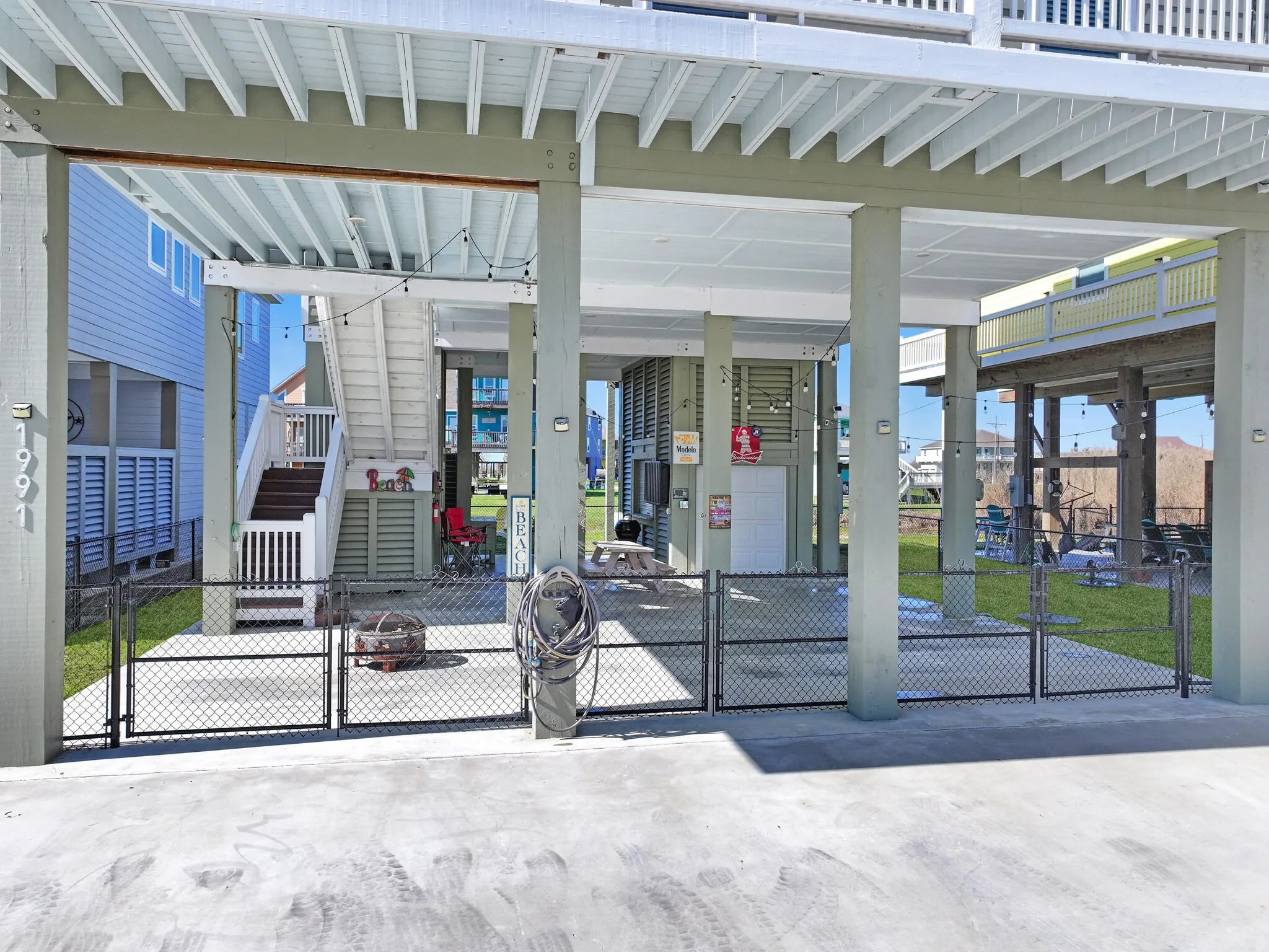 View of patio featuring a carport, fence, and a gate