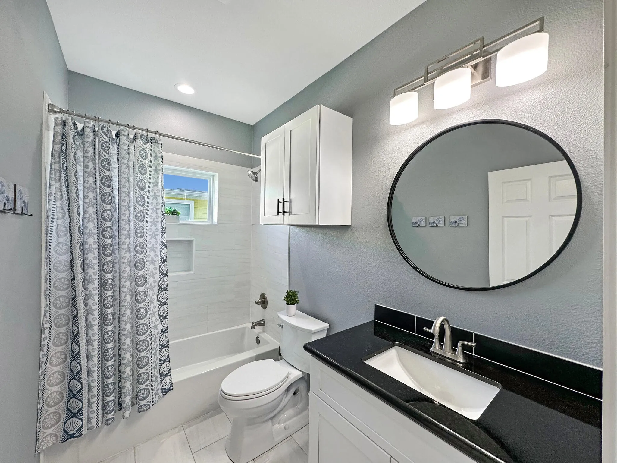 Bathroom with shower / tub combo, vanity, and toilet