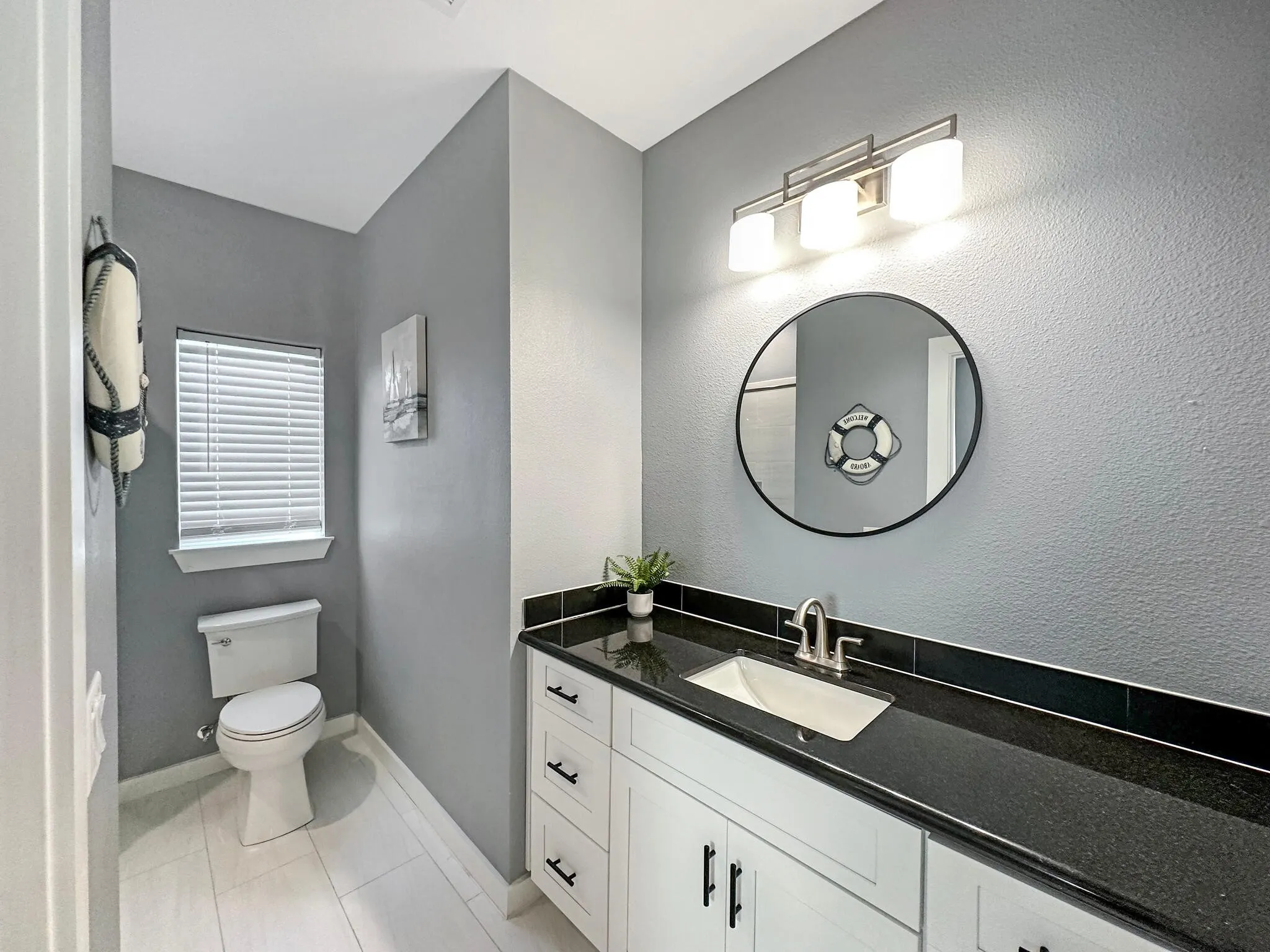 Bathroom featuring toilet, tile patterned flooring, baseboards, and vanity