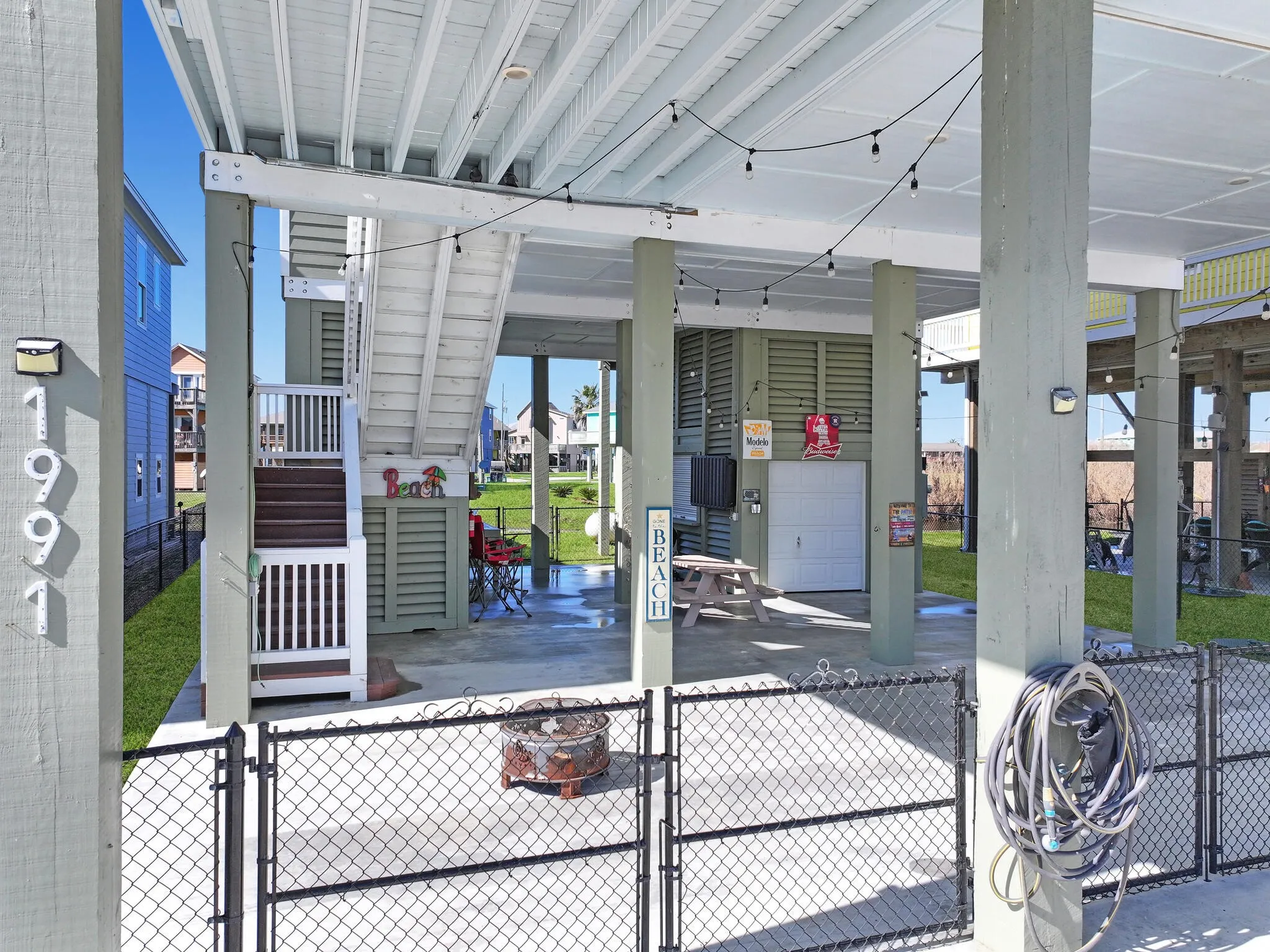 View of patio featuring fence and a gate