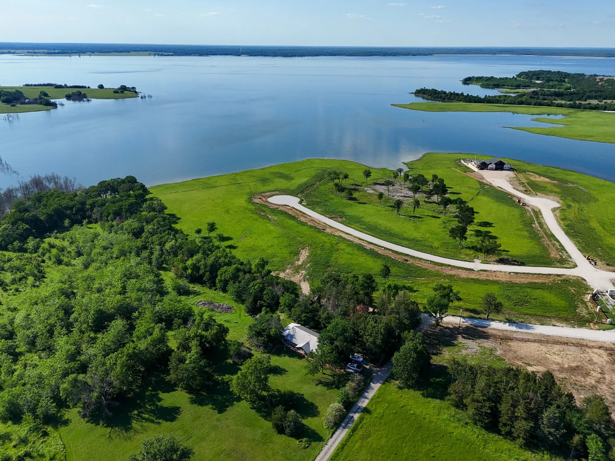 Birds eye view of property with a water view
