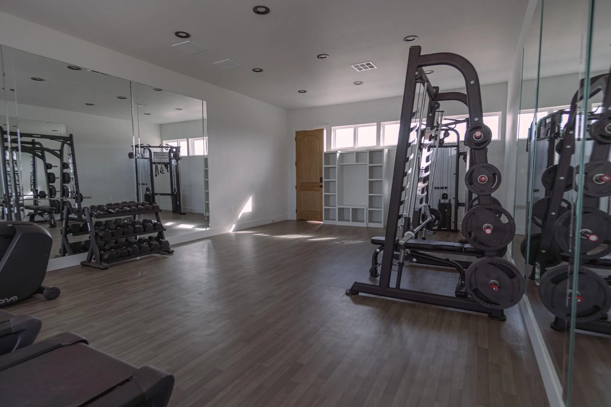 Workout area featuring visible vents, wood finished floors, baseboards, and recessed lighting