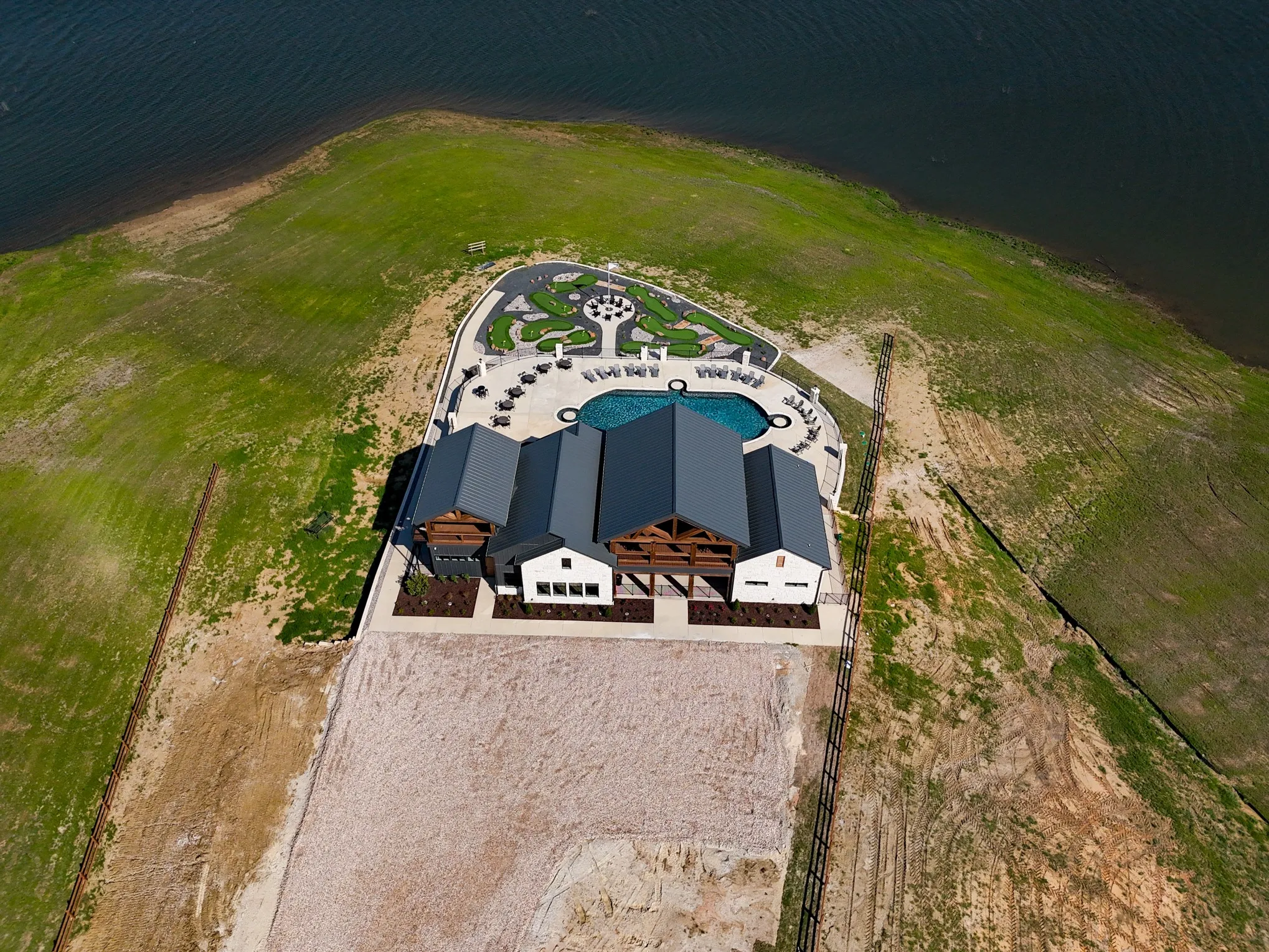 Birds eye view of property with a water view