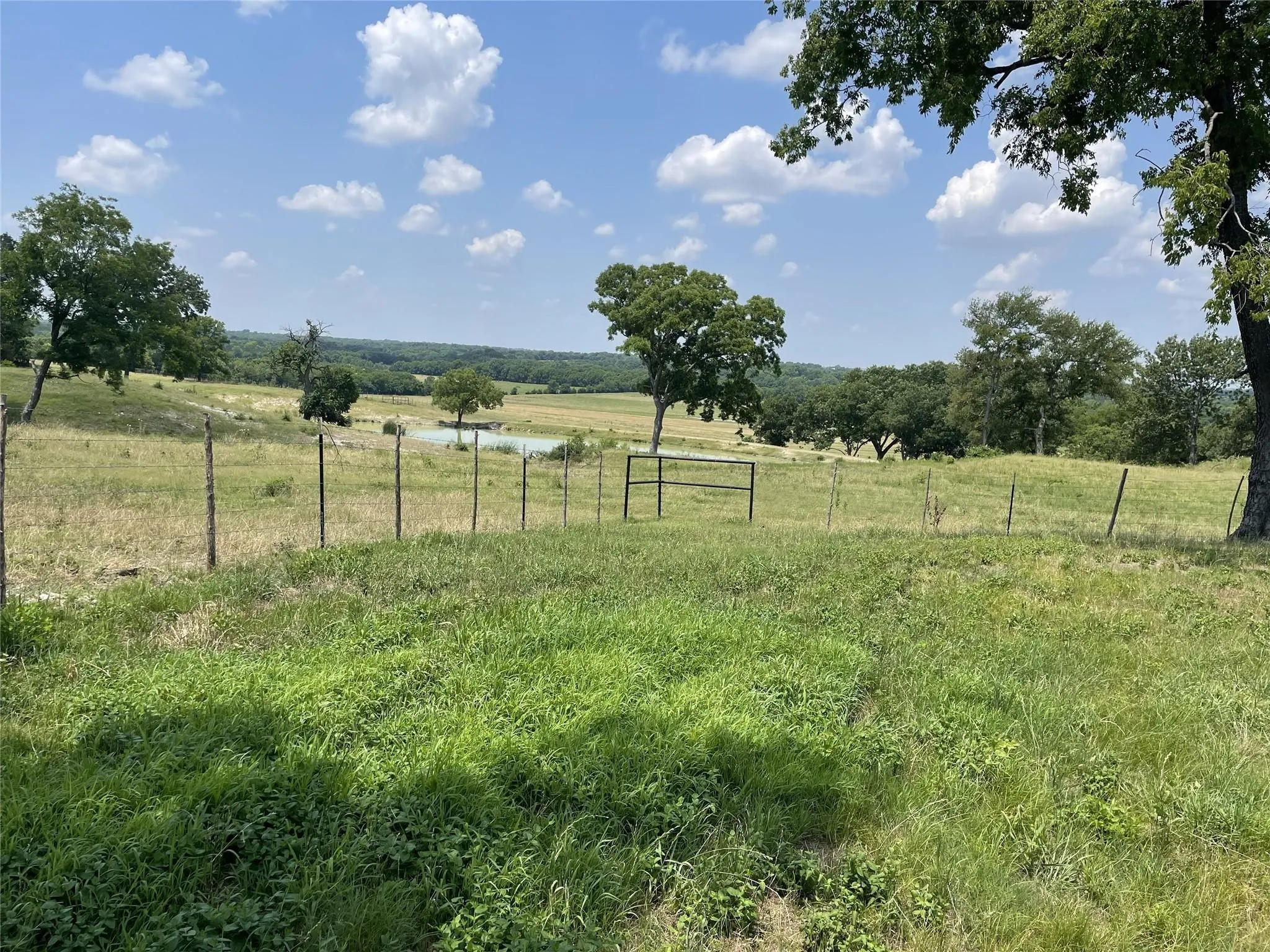 View of yard featuring a rural view and fence