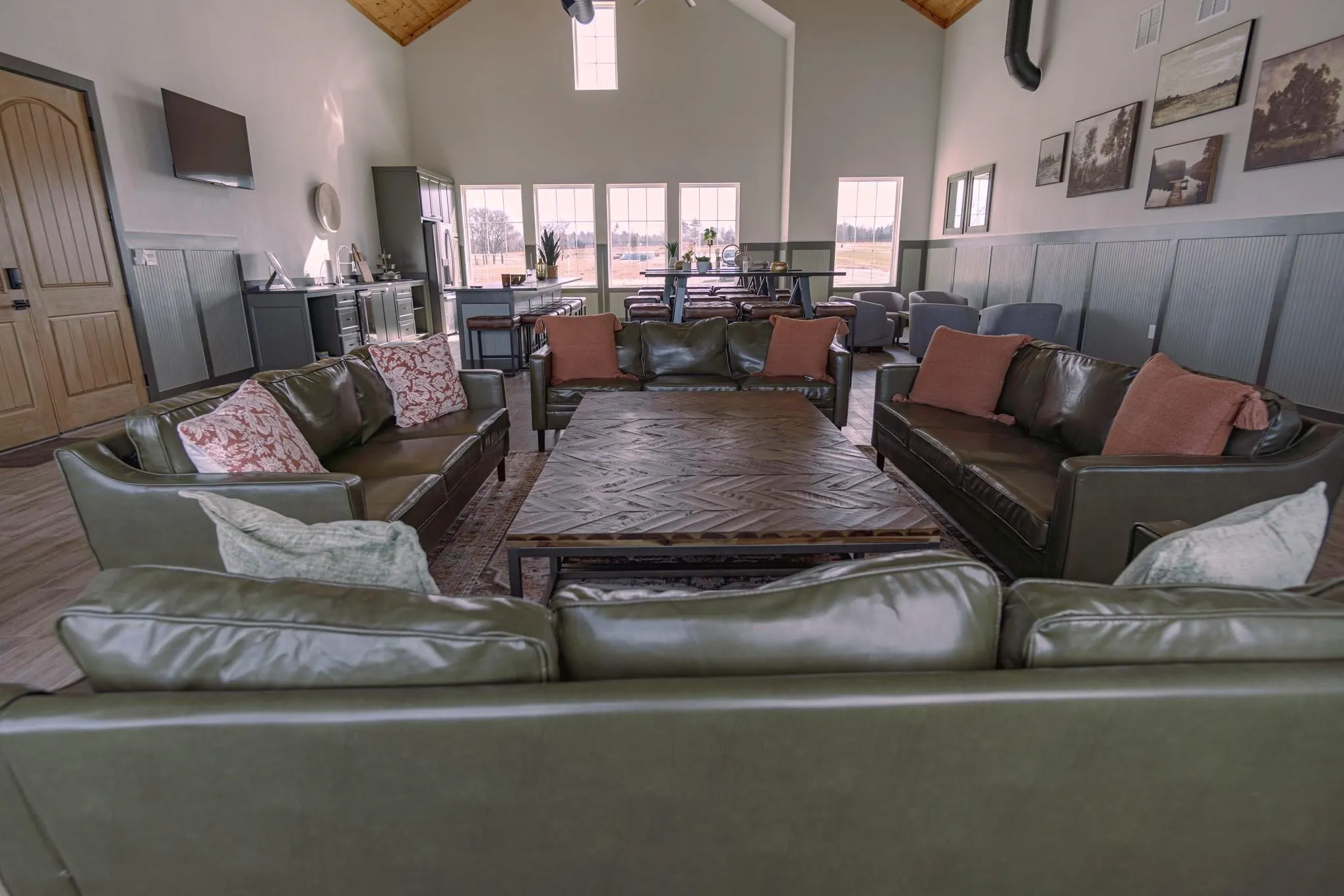Living area featuring a ceiling fan, high vaulted ceiling, and wood finished floors