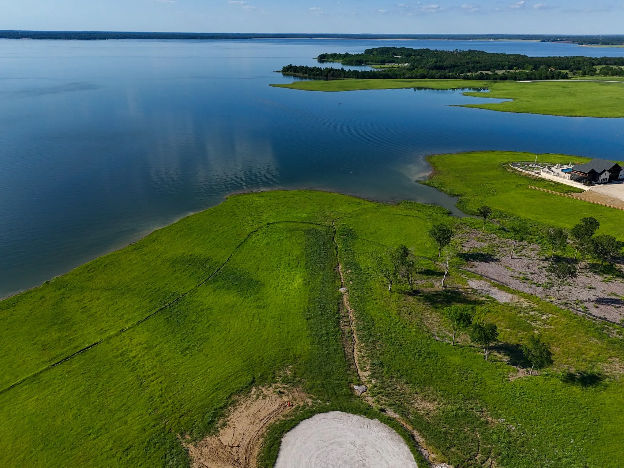 Birds eye view of property with a water view