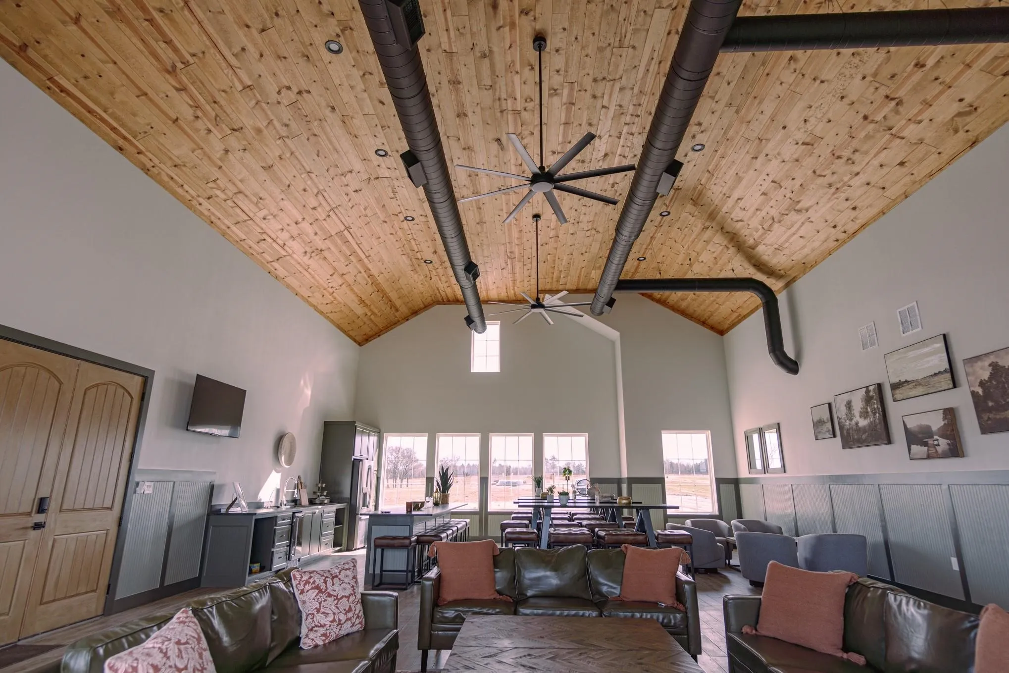Living room featuring ceiling fan, wood ceiling, high vaulted ceiling, and visible vents