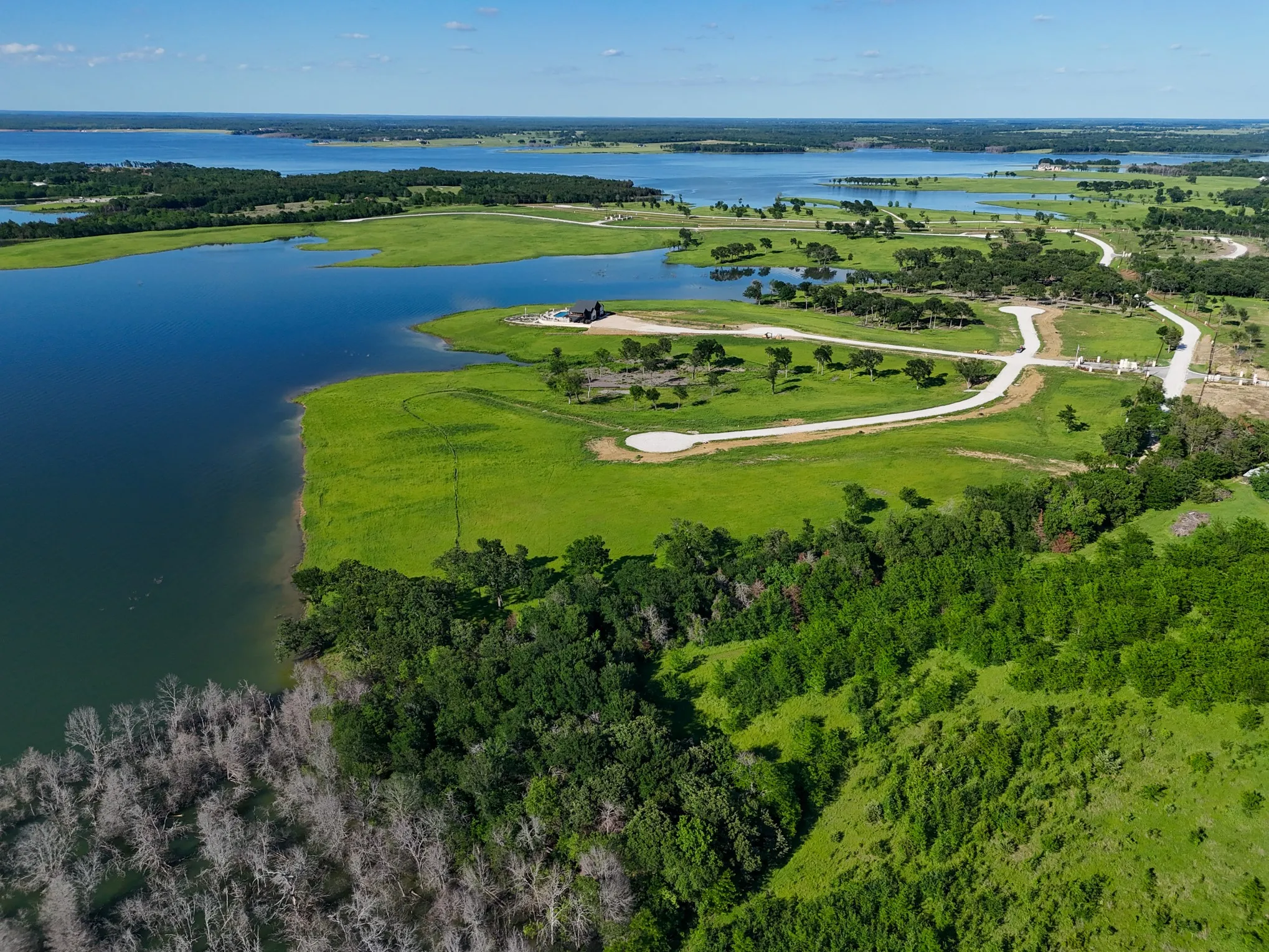Birds eye view of property with a water view