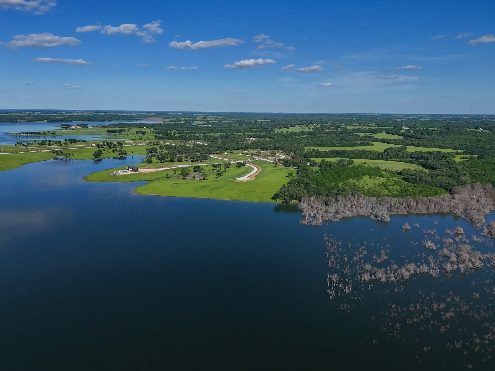 Birds eye view of property with a water view