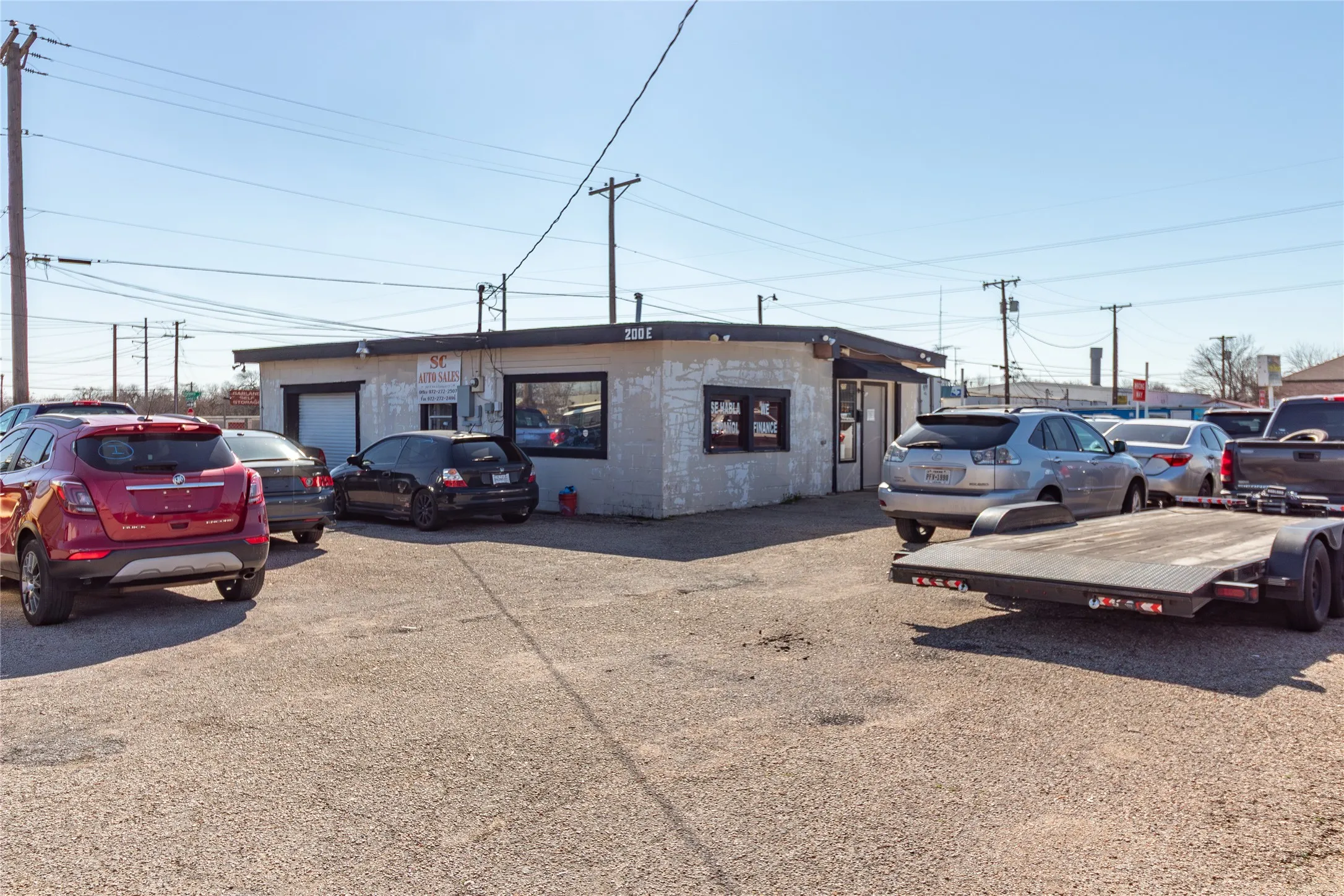 View of outdoor structure with uncovered parking