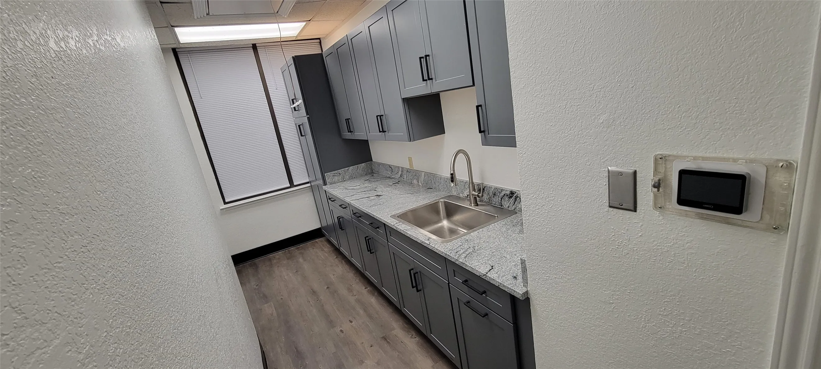 Kitchenette with new granite counter, sink, and cabinets