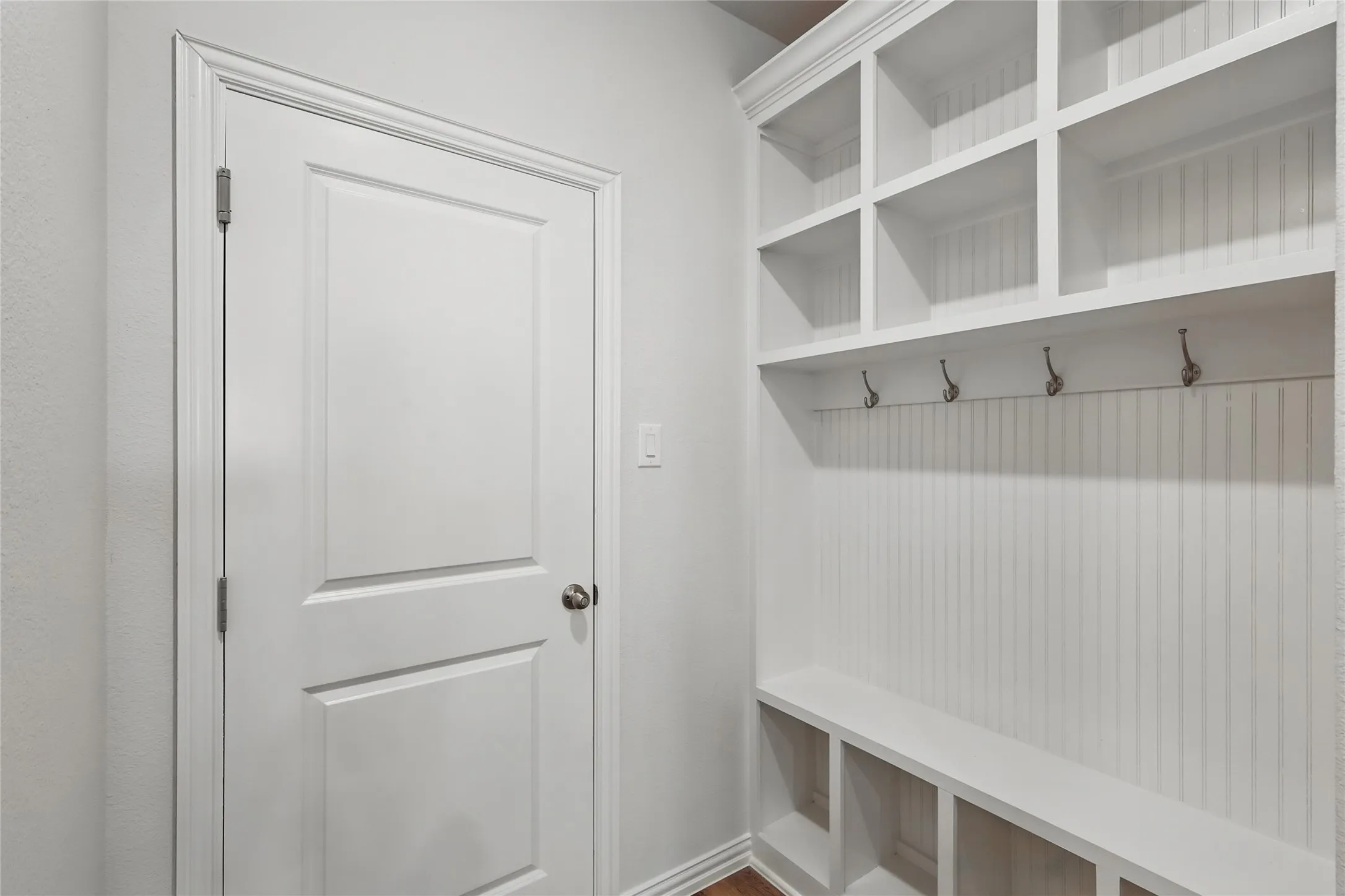 Mudroom with baseboards and wood finished floors
