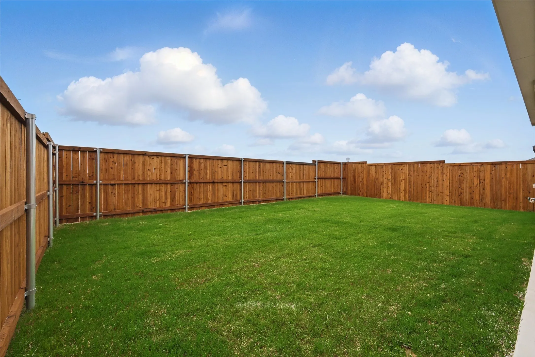 View of fenced backyard