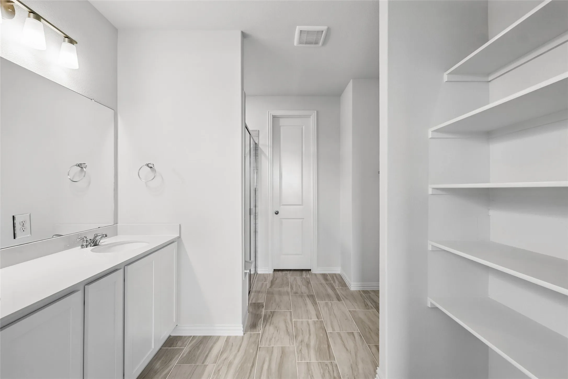 Full bath featuring vanity, a shower stall, and wood finish floors