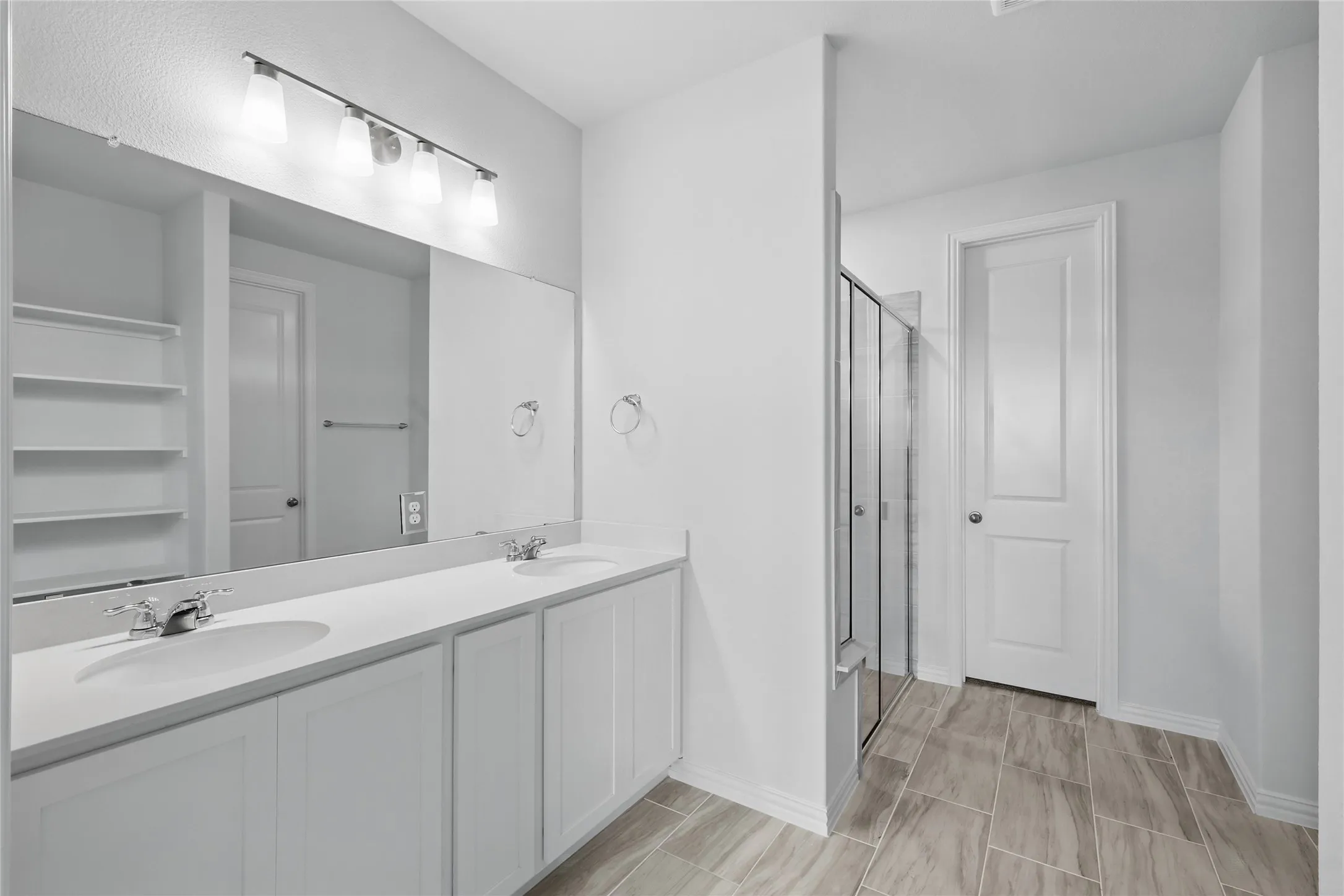 Bathroom with a stall shower and double vanity