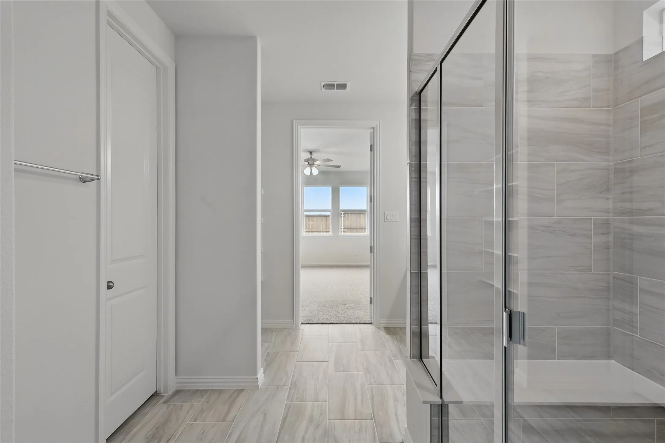 Bathroom with a shower stall and a ceiling fan