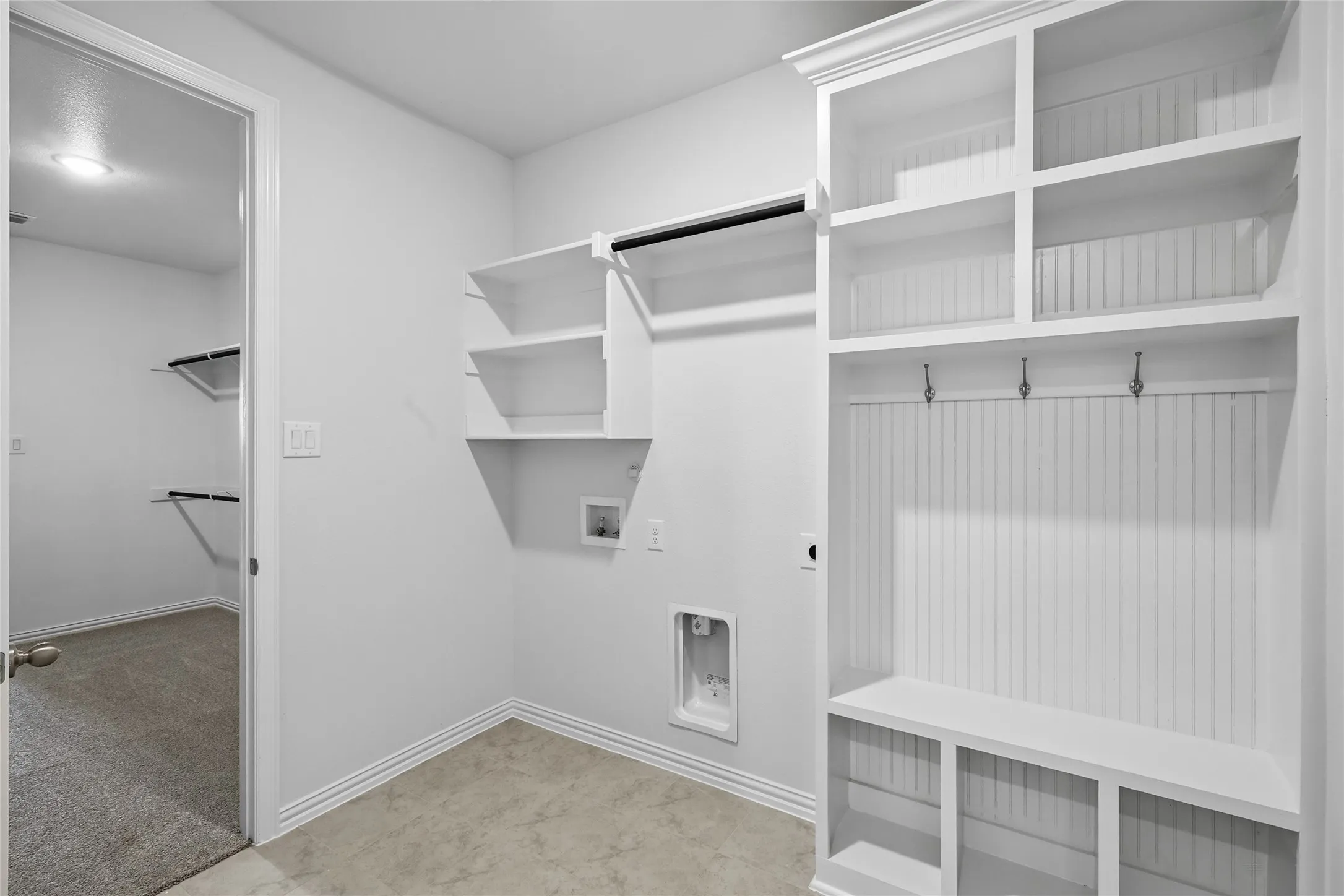 Laundry room with washer hookup, electric dryer hookup, and light colored carpet