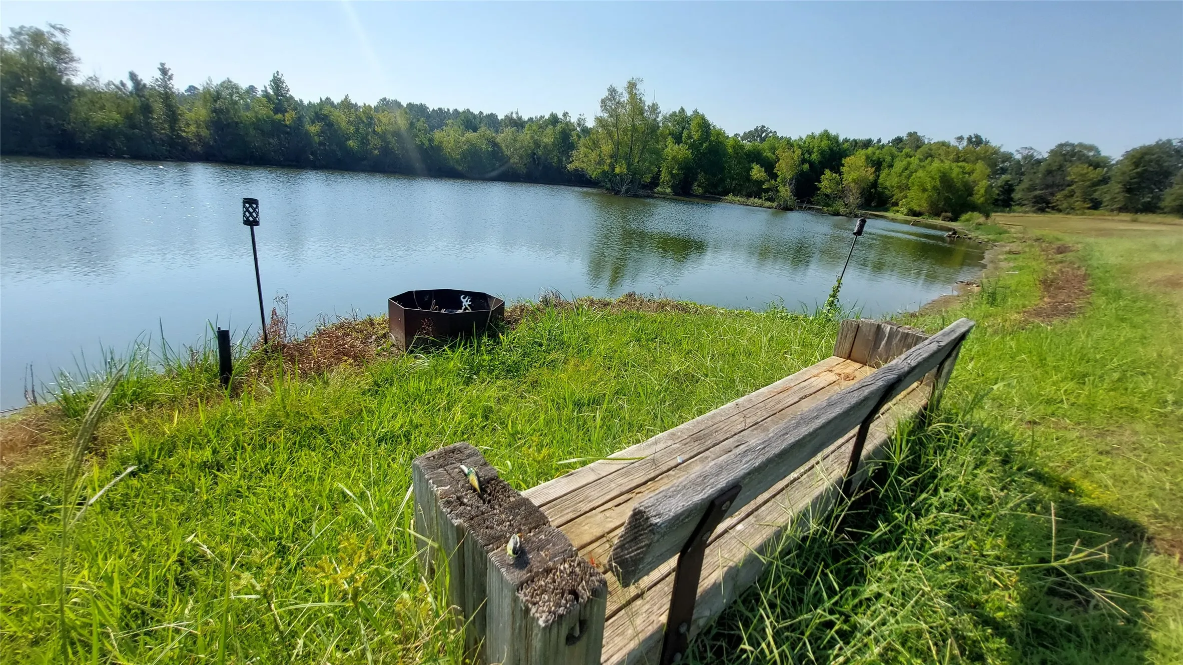 Property view of water with a wooded view