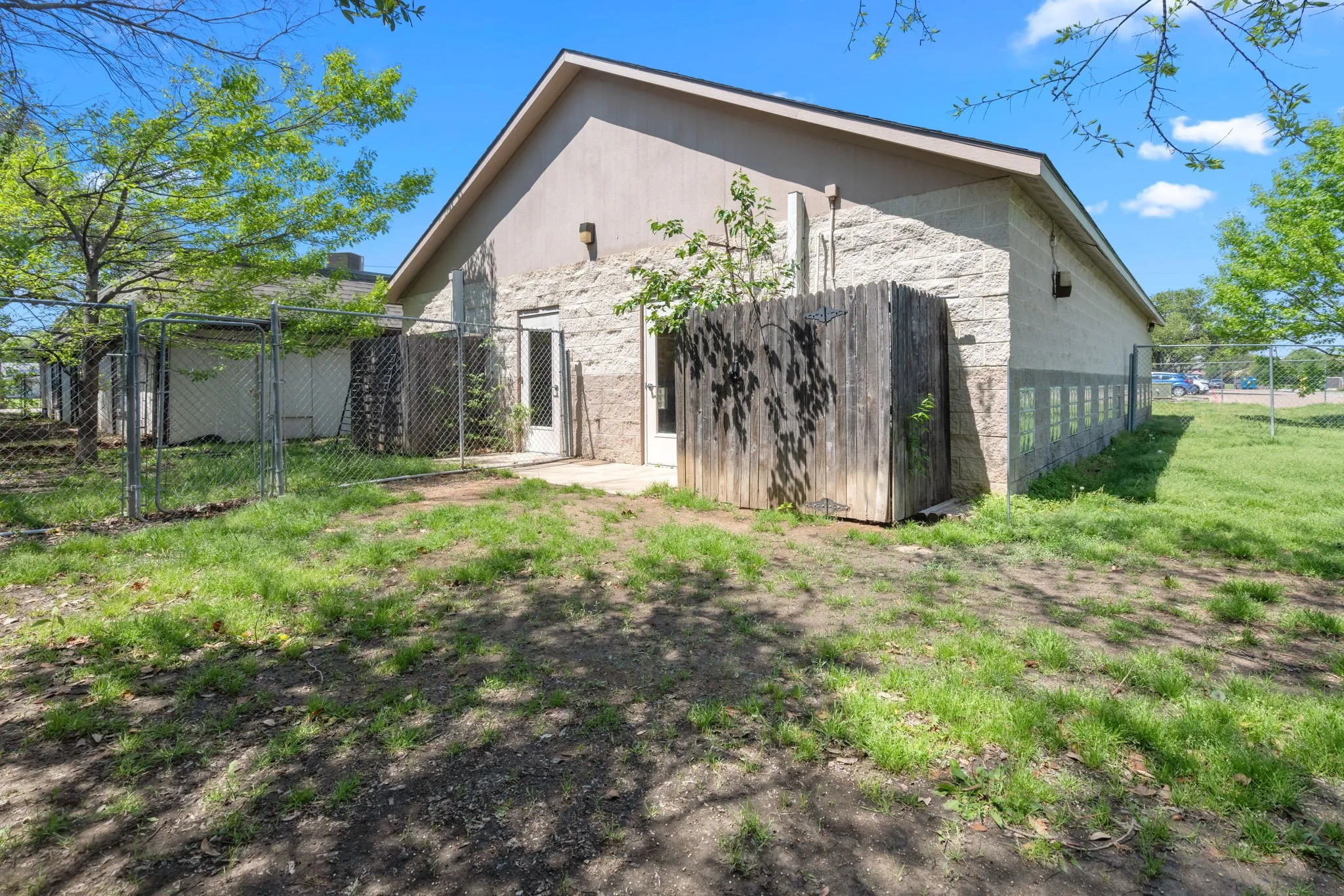 Back of building opens to grassed and tree shaded area