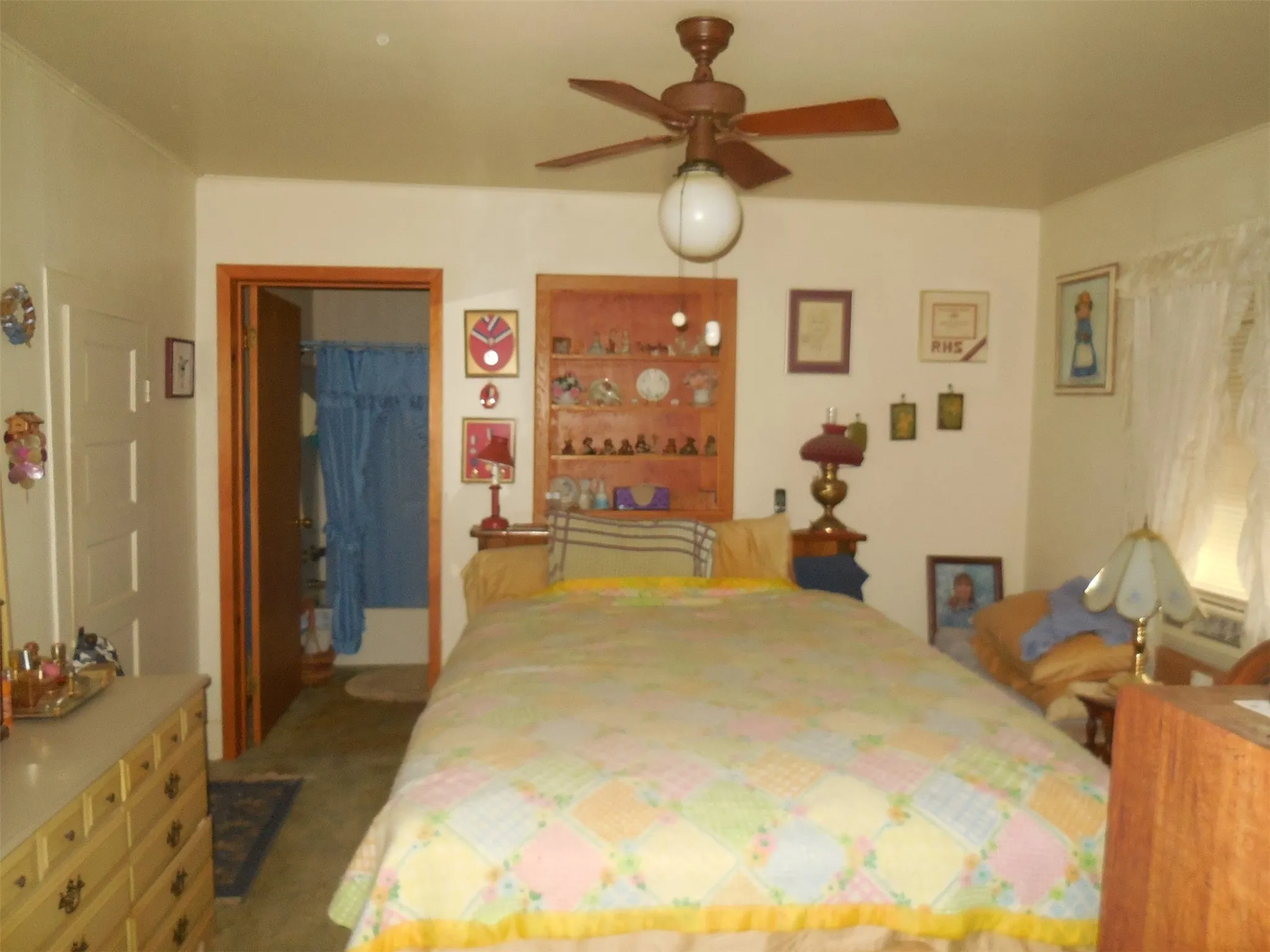 Carpeted bedroom featuring a closet, ceiling fan, and a spacious closet