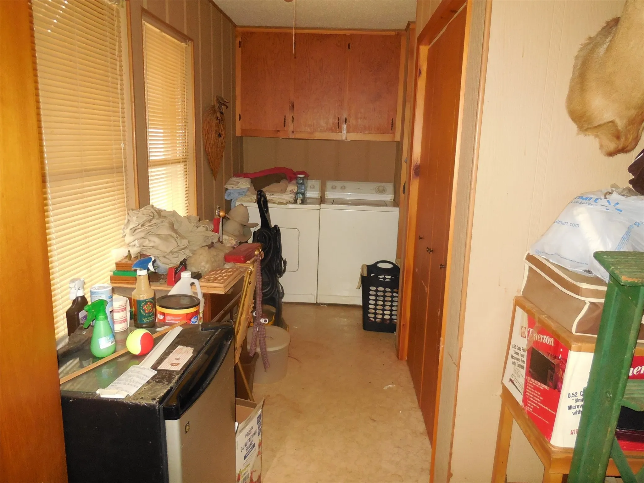 Large laundry area with storage.